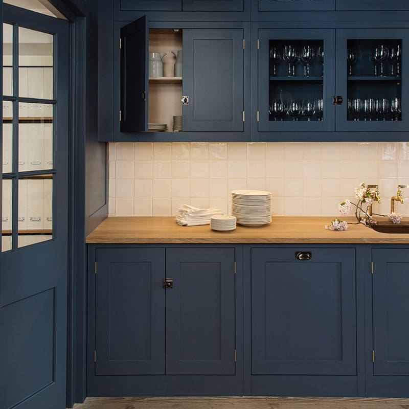 painted dark navy blue kitchen with wooden worktops
